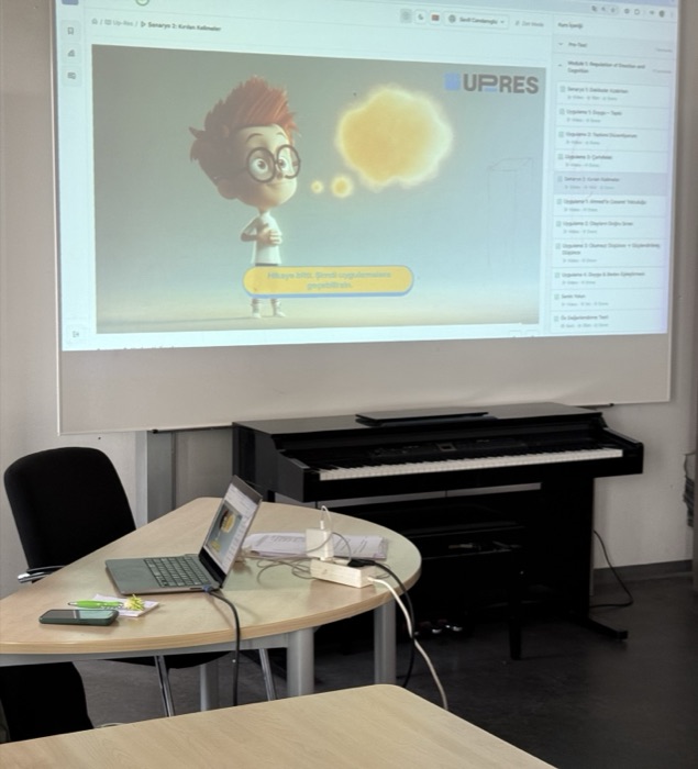 The UP-RES e-learning portal projected onto a classroom wall, showing a scenario from the module on regulating emotion and cognition.